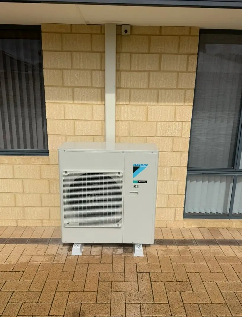 Daikin outdoor unit installed on a limestone wall in Dawesville