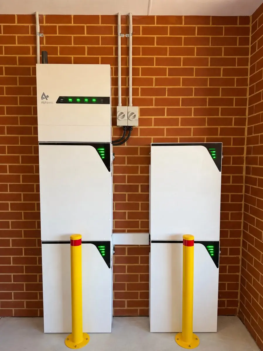 AlphaESS inverter with two battery stacks and bollards in a garage