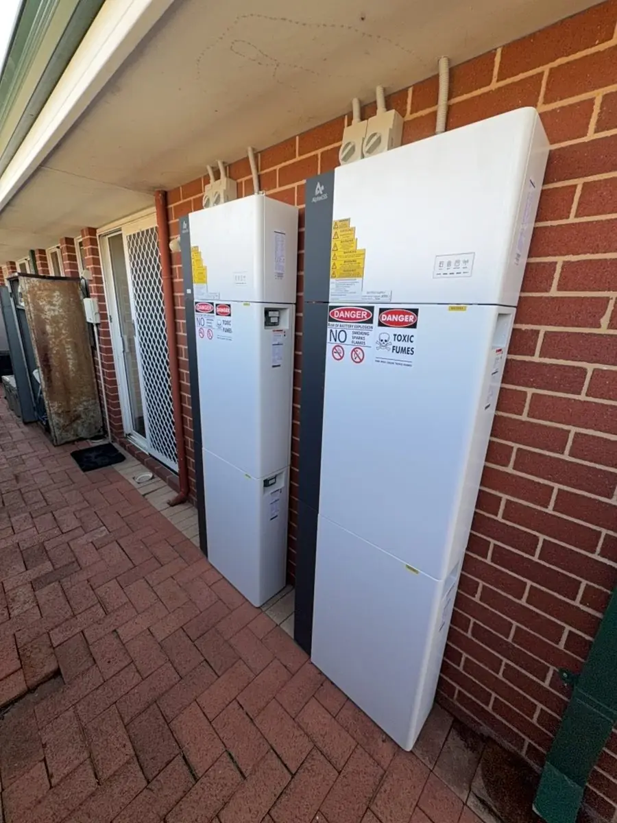 AlphaESS battery system on an outdoor brick wall